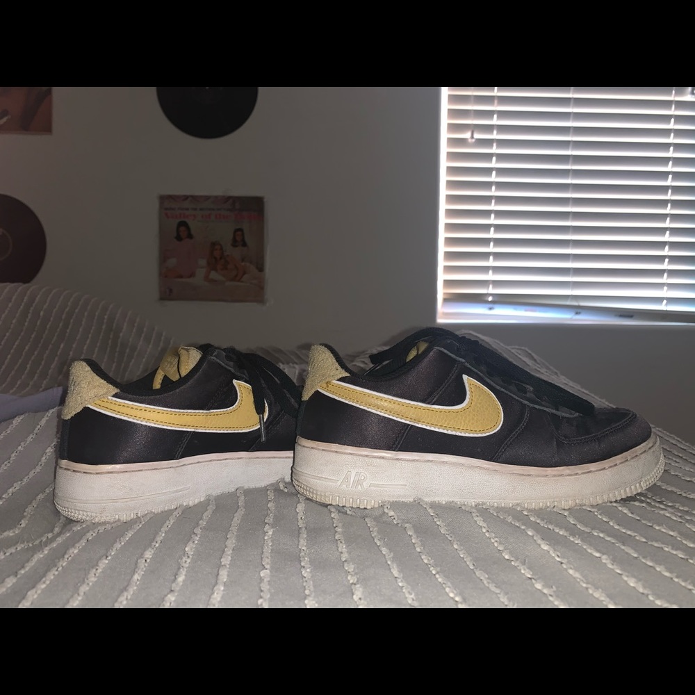 Black and gold Air Force ones